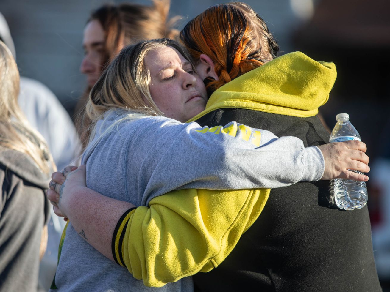 Alonso Garcia’s wife, Jess, hugs a friend at a vigil
for Alonso Garcia outside of a Latter-Day Saints meetinghouse at
5305 W. 5400 South in Kearns on Sunday March 14, 2021. Garcia was
shot and killed in the parking lot. Unified police have now
arrested a fourth person in connection with the March 9 killing.