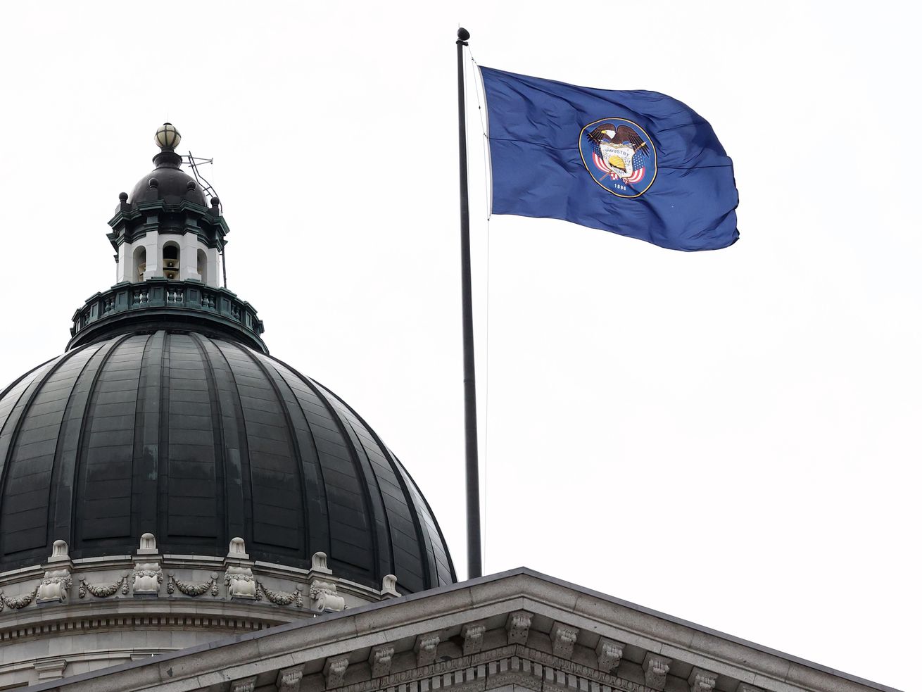The Utah flag flies over the state Capitol in Salt Lake
City on Jan. 22, 2021. Utah is among 21 states threatening legal
action against the Biden administration if it doesn’t clarify a
provision in the COVID-19 relief bill that appears to ban states
from cutting taxes.