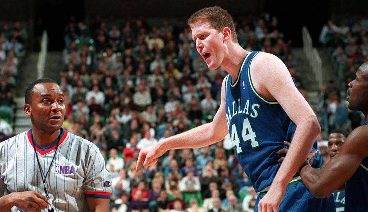 Mavericks center Shawn Bradley vents toward the referee as he is charged with a technical foul during the first half of a game against the Jazz. Mavs guard Robert Pack (right) tries to get Shawn to back down.