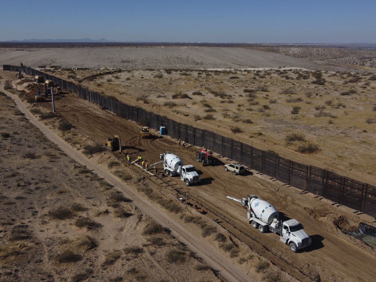 Workers prepare the foundation for a steel section of
border wall that will be built on the Mexican side of older metal
fencing dividing Ciudad Juarez, Mexico, from Sunland Park, New
Mexico, on the outskirts of Ciudad Juarez, Mexico, on Tuesday, Jan.
12, 2021. On Wednesday, March 17, 2021, Senate Republicans,
including Utah Sen. Mitt Romney, accused President Joe Biden of
violating federal law when he froze congressionally approved
funding for border wall construction, a move they say led to a rise
in illegal border crossings.