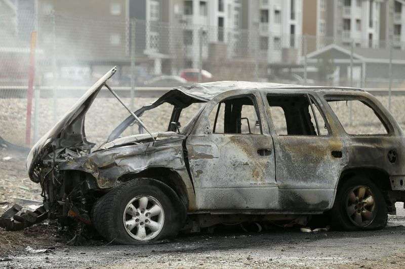 A vehicle burns after crashing off an embankment near
the Center Street overpass in Vineyard on Thursday, March 18,
2021.