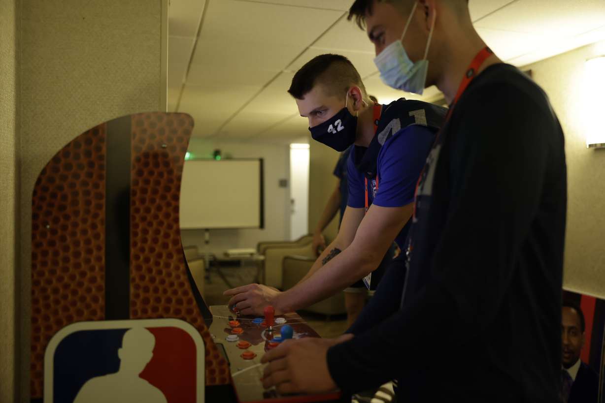 BYU's Alex Barcello and Richard Harward compete against each other in NBA Jam during downtime Wednesday, March 17, 2021, at the NCAA Tournament in Indianapolis.