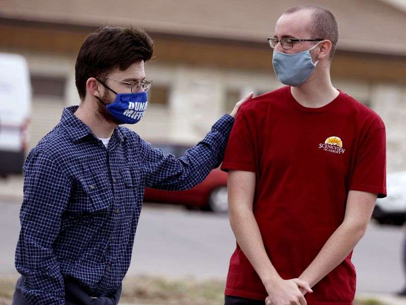 ScenicView Academy students Harrison Peterson, left,
and Dax Porter attend a groundbreaking ceremony for the 85 North
Apartments in Provo on Thursday, March 18, 2021. The seven-story,
74-unit building aims to address the shortage of affordable units
for senior citizens, the disabled and adults with autism. Both
Peterson and Porter hope to move into the apartment building after
its completion.