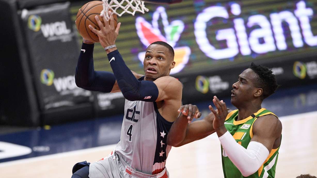 Washington Wizards guard Russell Westbrook (4) goes to the basket past Utah Jazz guard Miye Oni, right, during the second half of an NBA basketball game, Thursday, March 18, 2021, in Washington. (AP Photo/Nick Wass)