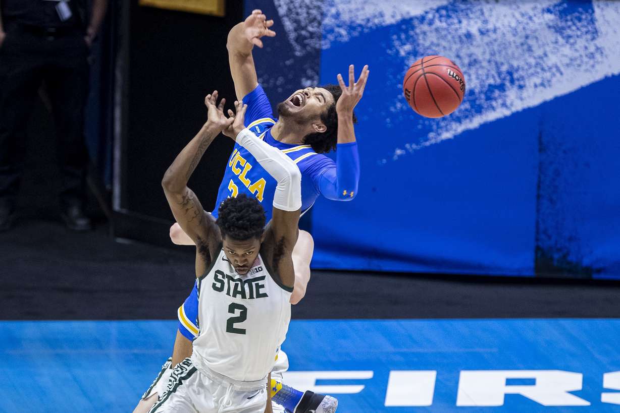 UCLA's Johnny Juzang (3) and Michigan State's Rocket Watts (2) compete for a rebound during the first half of a First Four game in the NCAA men's college basketball tournament Thursday, March 18, 2021, at Mackey Arena in West Lafayette, Ind.