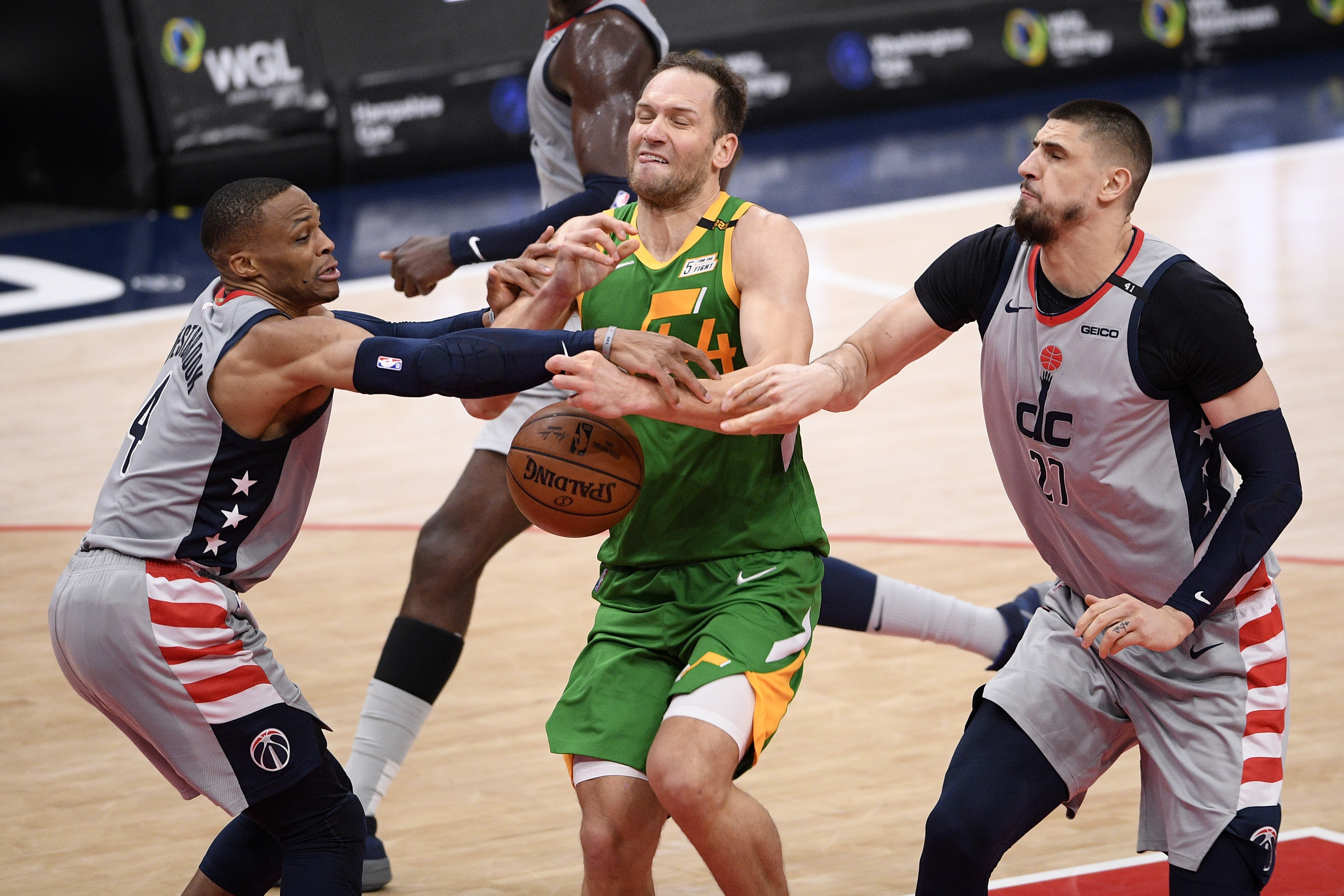 Utah Jazz forward Bojan Bogdanovic (44) loses the ball against Washington Wizards guard Russell Westbrook, left, and center Alex Len (27) during the first half of an NBA basketball game, Thursday, March 18, 2021, in Washington. (AP Photo/Nick Wass)