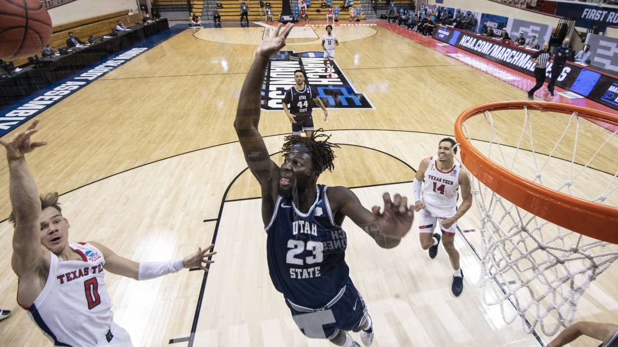 BLOOMINGTON, IN - MARCH 19: Neemias Queta #23 of the Utah State Aggies attempts to block a shot during the first round of the 2021 NCAA Division I Menâ??s Basketball Tournament against Texas Tech Red Raiders held at Simon Skjodt Assembly Hall on March 19, 2021 in Bloomington, Indiana. (Photo by Ben Solomon/NCAA Photos via Getty Images)*** Local Caption *** Neemias Queta