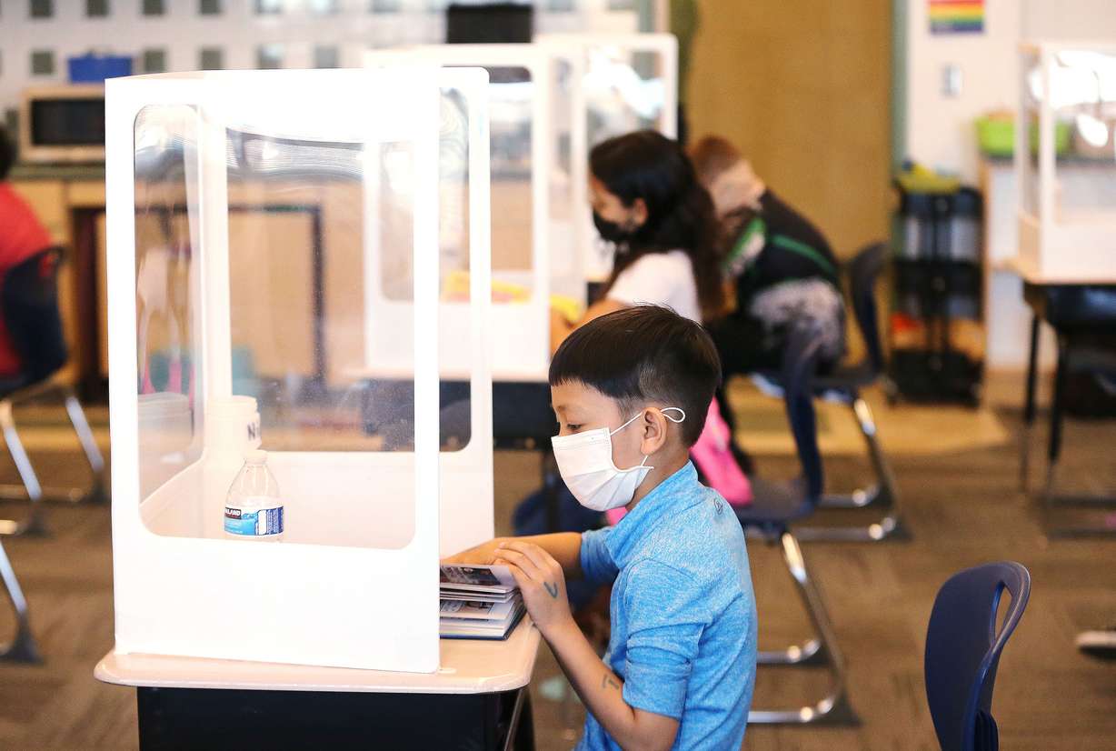 Third grader Nigh Phiwngam reads while maintaining social distance duirng a class at Washington Elementary School in Salt Lake City on Friday, March 19, 2021. The Utah HERO Project, a collaboration between University of Utah Health and the David Eccles School of Business announced findings from a major research study that helped inform new Centers for Disease Control and Prevention guidance.