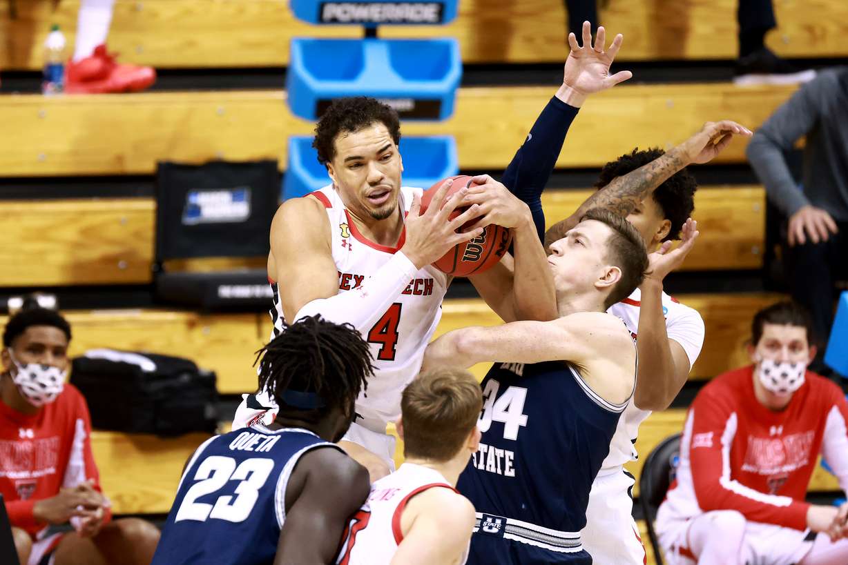 Marcus Santos-Silva of the Texas Tech Red Raiders battles Justin Bean of the Utah State Aggies for a rebound in the first round of the 2021 NCAA Division I Men’s Basketball Tournament held at Simon Skjodt Assembly Hall on March 19, 2021 in Bloomington, Indiana.