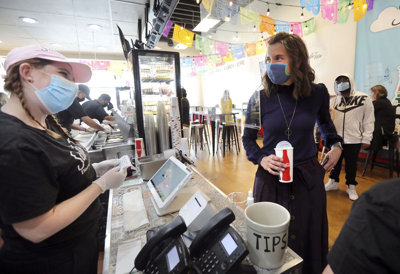 Marianna Skalla takes an order from Salt Lake City
Mayor Erin Mendenhall at Santo Taco in Salt Lake City on Friday,
March 19, 2021. Mendenhall is asking Salt Lake City businesses to
continue asking patrons and staff to wear masks after the state
mask mandate is lifted on April 10.