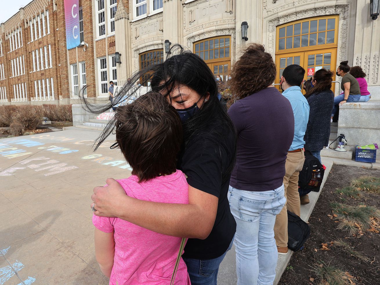 Kathryn Kay Coquemont, associate vice president for
student success at Salt Lake Community College, facing camera, hugs
a vigil attendee at the college’s campus in Salt Lake City on
Friday, March 19, 2021. The Peace and Justice vigil was held in
memory of the victims of the recent shootings in Atlanta.