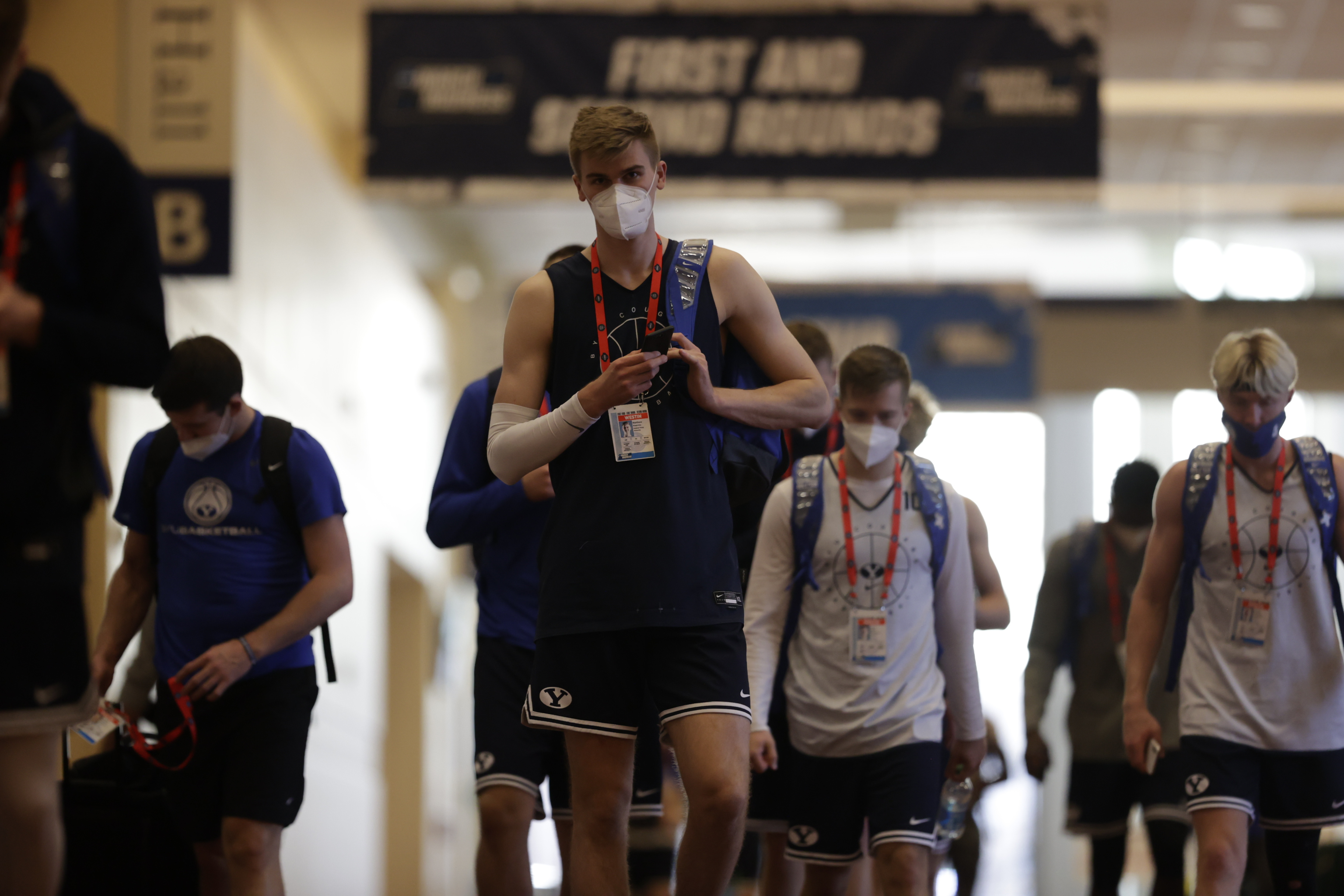 Matt Haarms motions to the camera as he, Jesse Wade and Hunter Erickson headed to practice with BYU basketball, Friday, March 19, 2021 at the NCAA Tournament in Indianapolis. 