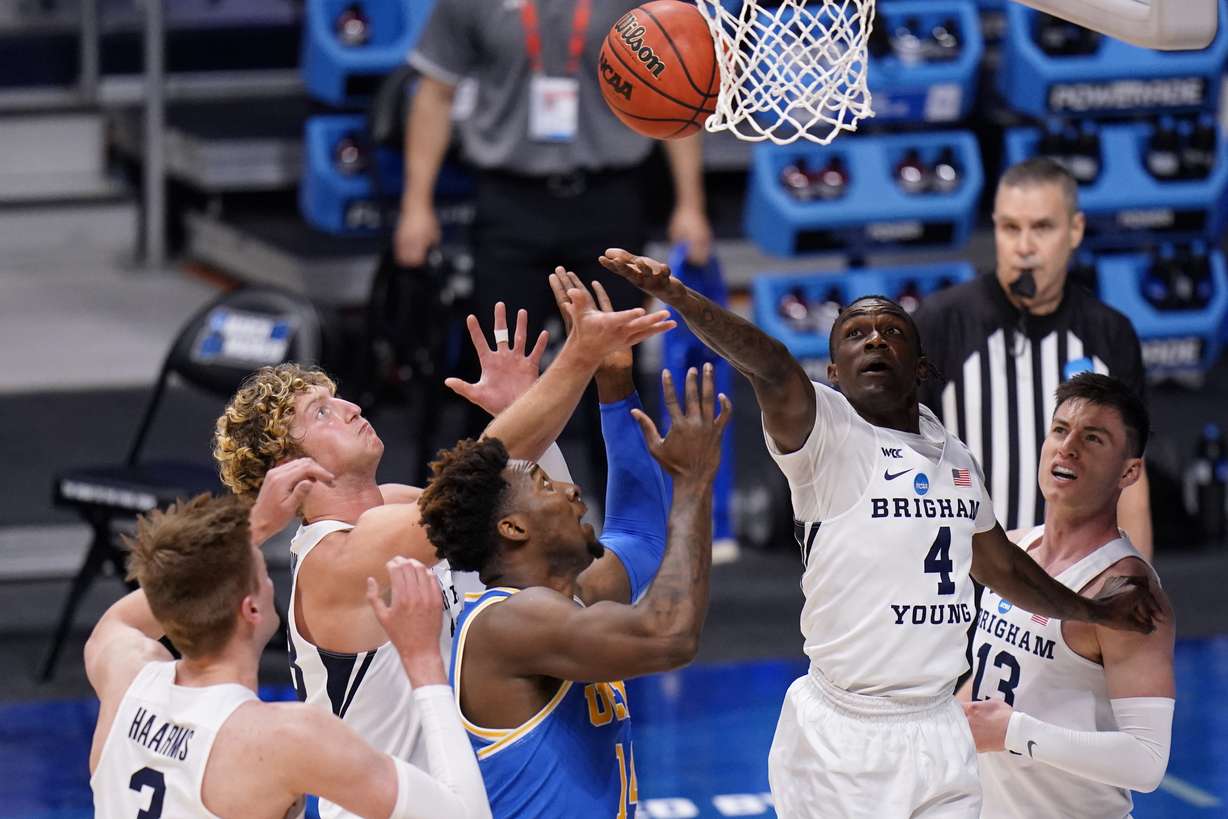 BYU guard Brandon Averette (4) reaches for a rebound with UCLA forward Kenneth Nwuba (14) and BYU forward Caleb Lohner, second from left, and BYU forward Matt Haarms (3) during the second half of a first-round game in the NCAA college basketball tournament at Hinkle Fieldhouse in Indianapolis, Saturday, March 20, 2021.