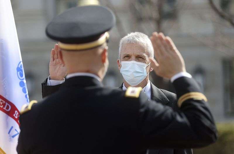 Col. Thomas Hrabal, with the 807th Medical Command at
Fort Douglas, swears Dr. John Mitchell into the U.S. Army Reserves
as a colonel outside of the Capitol in Salt Lake City on Wednesday,
March 17, 2021. Mitchell previously served 20 years in the Army
before working as a cardiothoracic surgeon with Intermountain
Healthcare at Utah Valley Hospital.