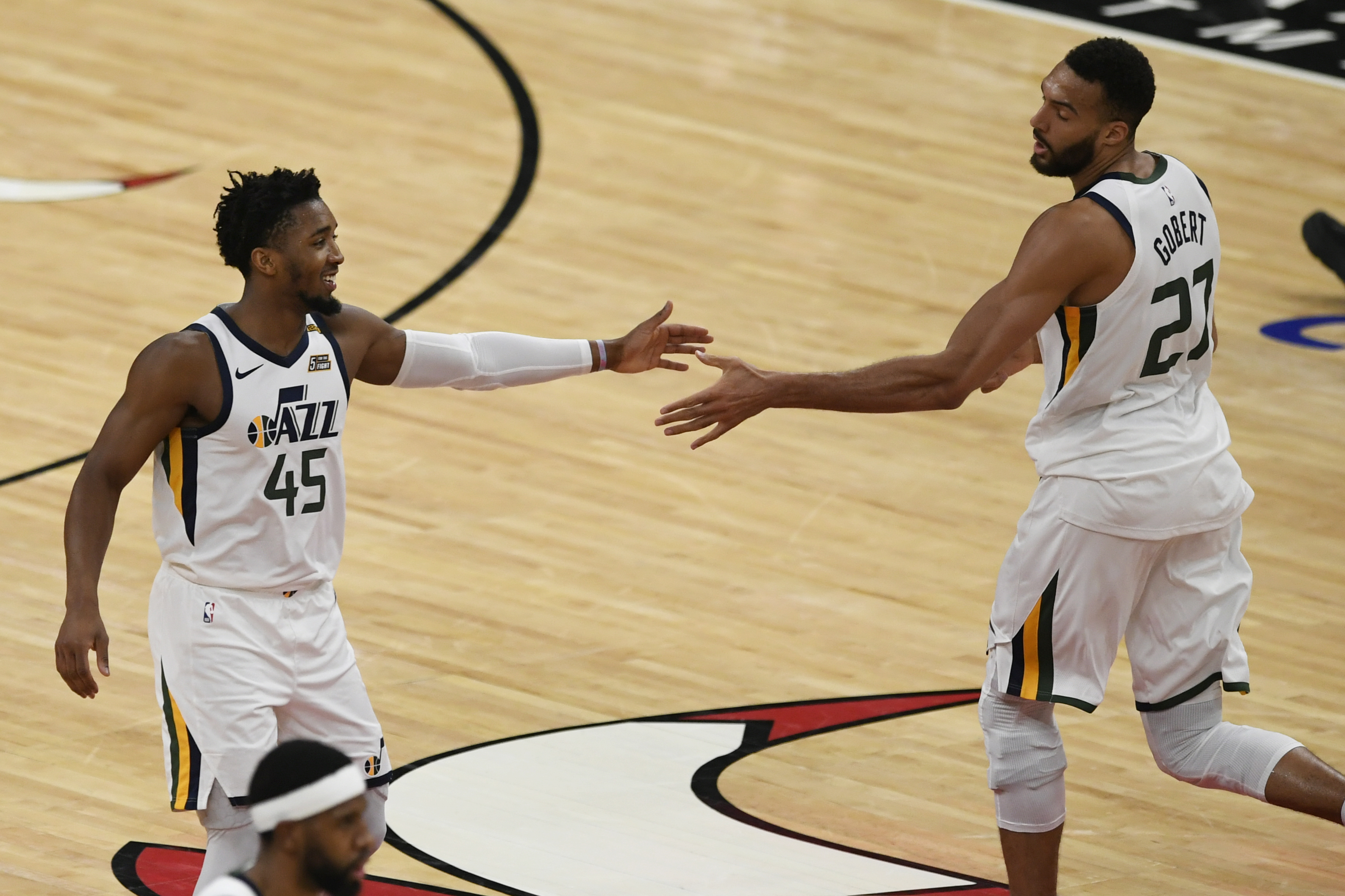 Utah Jazz's Donovan Mitchell (45) celebrates with Rudy Gobert (27) during the first half of the team's NBA basketball game against the Chicago Bulls Monday, March 22, 2021, in Chicago. 
