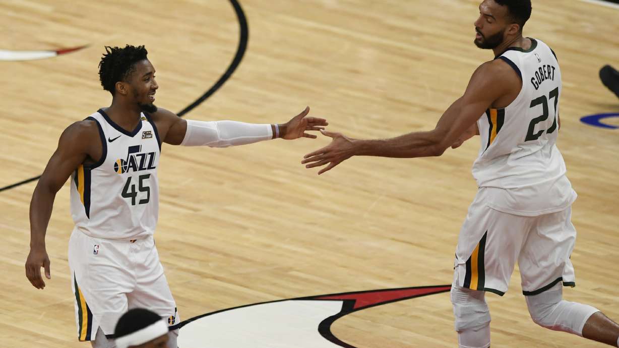 Utah Jazz's Donovan Mitchell (45) celebrates with Rudy Gobert (27) during the first half of the team's NBA basketball game against the Chicago Bulls Monday, March 22, 2021, in Chicago.