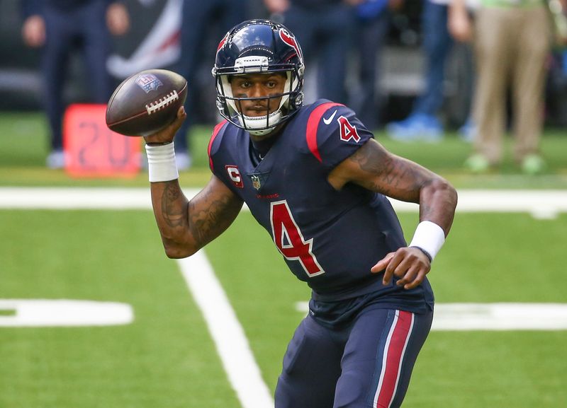 FILE PHOTO: Dec 27, 2020; Houston, Texas, USA; Houston Texans quarterback Deshaun Watson (4) rolls out of the pocket against the Cincinnati Bengals during the third quarter at NRG Stadium.  Troy Taormina-USA TODAY Sports