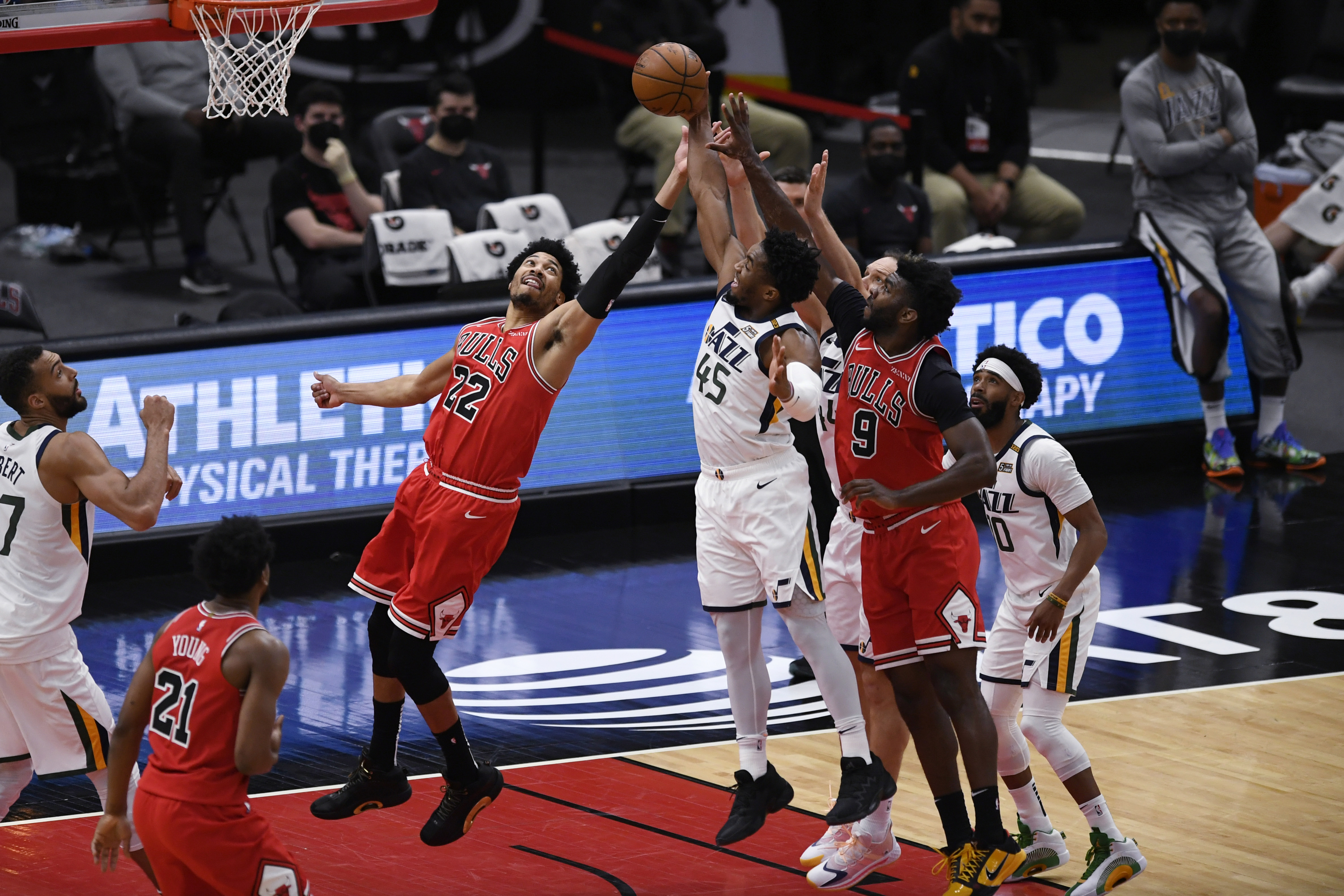 Chicago Bulls' Otto Porter Jr. (22) and Patrick Williams (9) and Utah Jazz's Donovan Mitchell (45) and Bojan Bogdanovic (44) vie for a rebound during the first half of an NBA basketball game Monday, March 22, 2021, in Chicago. (AP Photo/Paul Beaty)