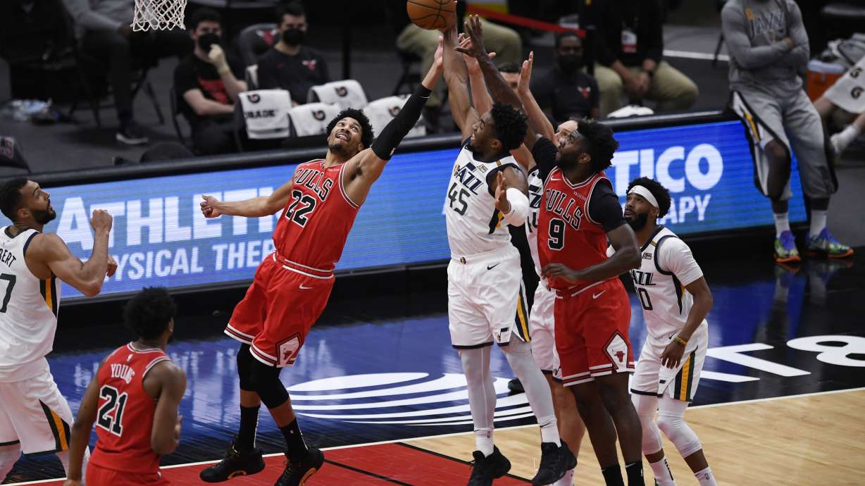 Chicago Bulls' Otto Porter Jr. (22) and Patrick Williams (9) and Utah Jazz's Donovan Mitchell (45) and Bojan Bogdanovic (44) vie for a rebound during the first half of an NBA basketball game Monday, March 22, 2021, in Chicago. (AP Photo/Paul Beaty)