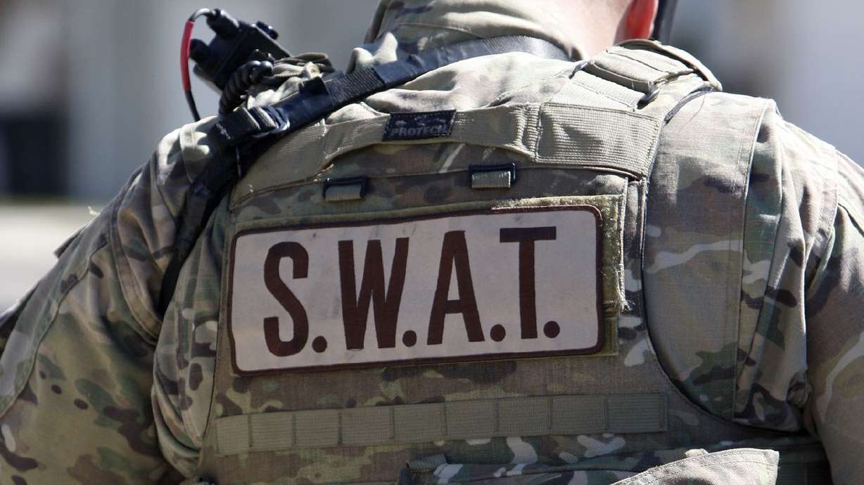 A SWAT team member responds to a Pleasant Grove
incident in this March 20, 2015, photo. On Wednesday, a Pleasant
Grove man was charged with assault on a police officer, illegal
discharge of a firearm and aggravated assault following a six-hour
standoff on March 16 during which he allegedly shot at officers.