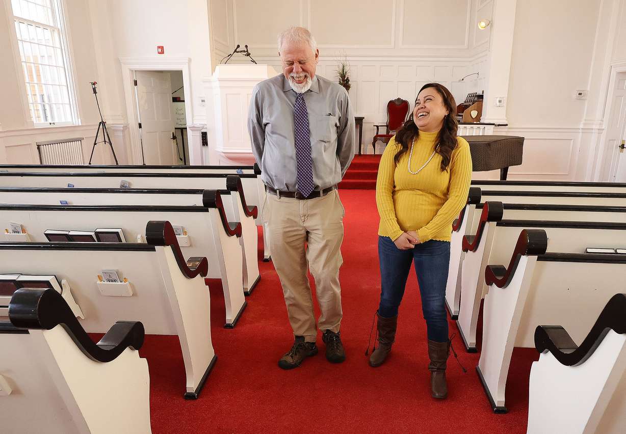 The Rev. Tom Golsmith, left, shares a laugh with Vicky Chavez at the First Unitarian Church of Salt Lake City in Salt Lake City on Wednesday, March 24, 2021. Chavez, who for three years has sought sanctuary with her young daughters at the church, and three other women in similar situations in other states are suing U.S. immigration officials, alleging they are facing steep fines because they spoke out about their cases.