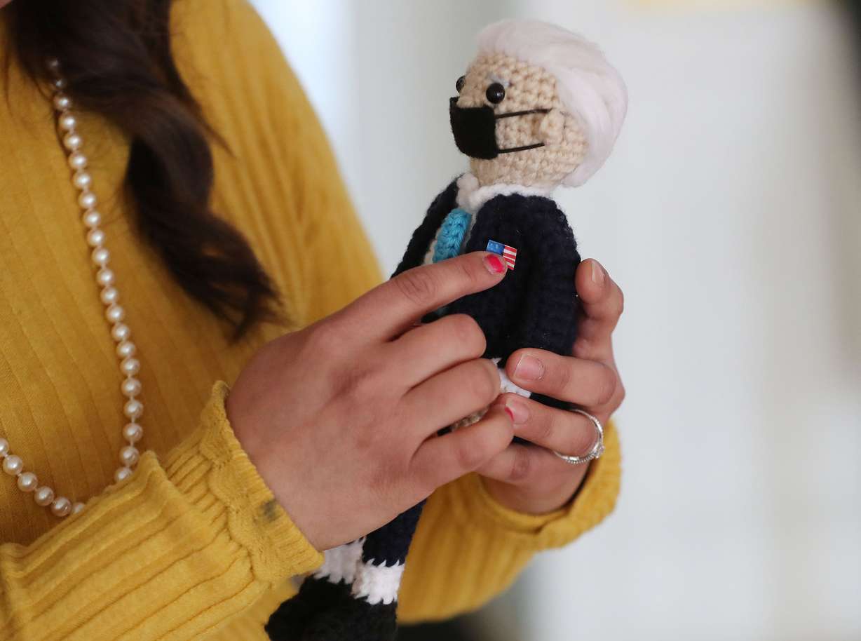 Vicky Chavez, who for three years has sought sanctuary with her young daughters at the First Unitarian Church of Salt Lake City, holds a doll of President Joe Biden she crocheted on Wednesday, March 24, 2021. Chavez and three other women in similar situations in other states are suing U.S. immigration officials, alleging they are facing steep fines because they spoke out about their cases.