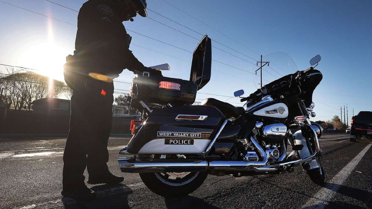 West Valley officer Gary Lipscomb issues a traffic
violation in a school zone in West Valley City on Wednesday, March
24, 2021.