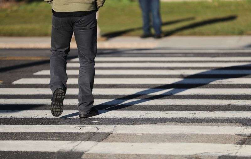 A decoy pedestrian walks in a school crosswalk in West
Valley City on Wednesday, March 24, 2021, as West Valley police
conduct a crosswalk safety operation. A crosswalk that has a
pattern of wide striped lines running from curb to curb — like a
ladder — is a designated school crosswalk. According to state law,
a motorist must wait for a pedestrian to walk all the way across
the street to the opposite sidewalk before proceeding, whether
school is in session or not.