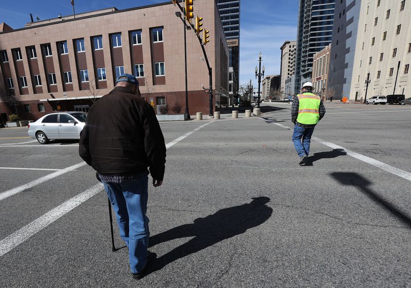Pedestrian walk in a crosswalk on State Street and 100
South in Salt Lake City on Wednesday, March 24, 2021. For a
crosswalk with just two solid parallel lines stretching from curb
to curb, a driver only has to wait for a pedestrian to reach the
other half of the street, or the portion of the street that the
vehicle is not traveling on.