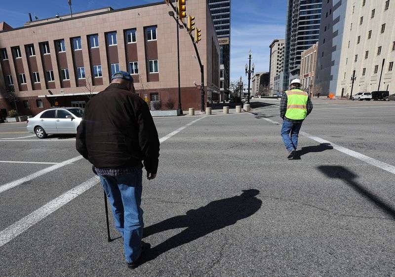 Pedestrian walk in a crosswalk on State Street and 100
South in Salt Lake City on Wednesday, March 24, 2021. For a
crosswalk with just two solid parallel lines stretching from curb
to curb, a driver only has to wait for a pedestrian to reach the
other half of the street, or the portion of the street that the
vehicle is not traveling on.