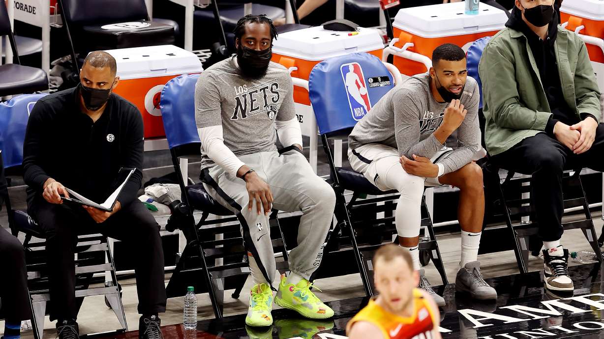 Brooklyn Nets guard James Harden (13) who didn’t play watches the action from the bench as the Jazz and the Nets play an NBA basketball game at Vivint Smart Home Arena in Salt Lake City on Wednesday, March 24, 2021. Utah won 118-88.