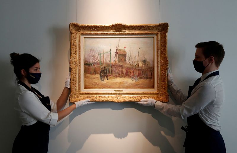 FILE PHOTO: Sotheby's Paris employees pose with the 1887 painting of a Paris street scene "Scene de rue a Montmartre" by Dutch painter Vincent Van Gogh which will be presented to the public for the first time after spending more than a century behind closed doors in the private collection of a French family, France, February 24, 2021.  REUTERS/Christian Hartmann