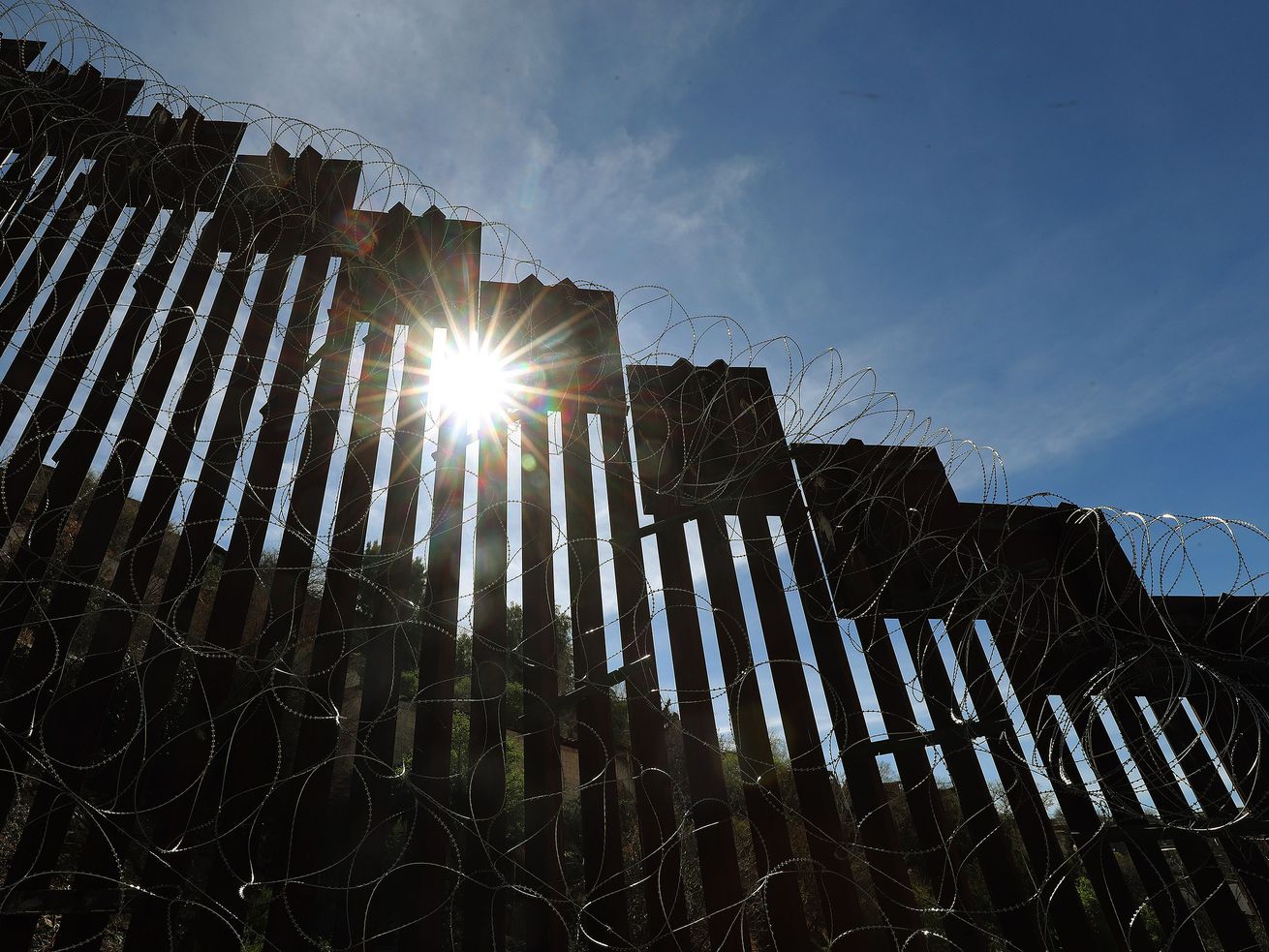 Sun shines through the U.S.-Mexico border wall in
Nogales, Arizona, on Feb. 12, 2019. A day after condemning the
Biden administration for causing a crisis on the U.S. border with
Mexico, Sen. Mike Lee plans to travel to the Southwest to get a
firsthand look at the surge migrants seeking asylum.