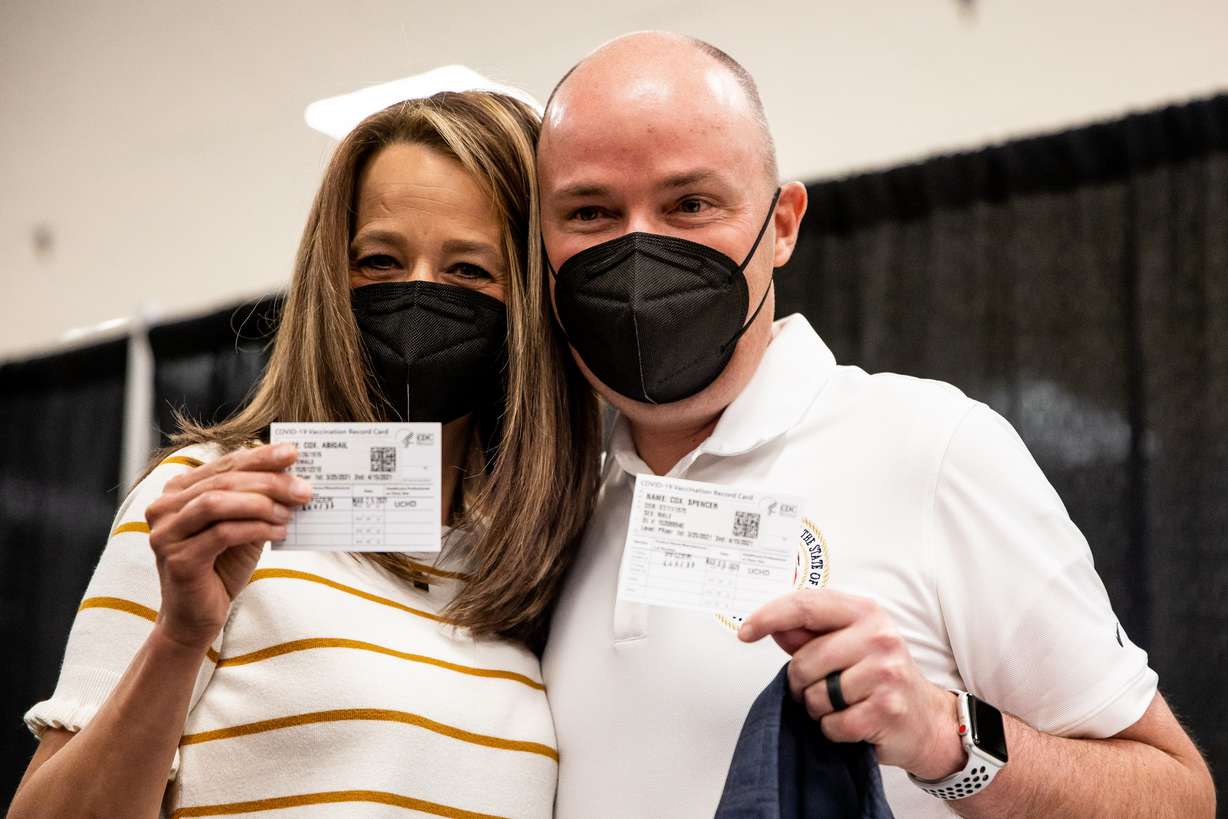 Utah first lady Abby Cox, left, and her husband, Gov. Spencer Cox, pose for photos with their vaccination cards after they reach received their first dose of the Pfizer-BioNTech COVID-19 vaccine at a vaccination site run by the Utah County Health Department in Spanish Fork on Thursday, March 25, 2021.
