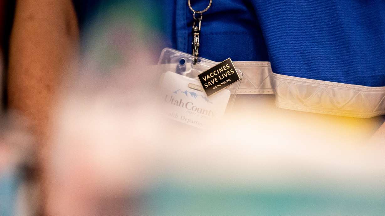 Nurse Amy Engle wears a pin that reads â??Vaccines save livesâ? at a COVID-19 vaccination site run by the Utah County Health Department in Spanish Fork on Thursday, March 25, 2021.
