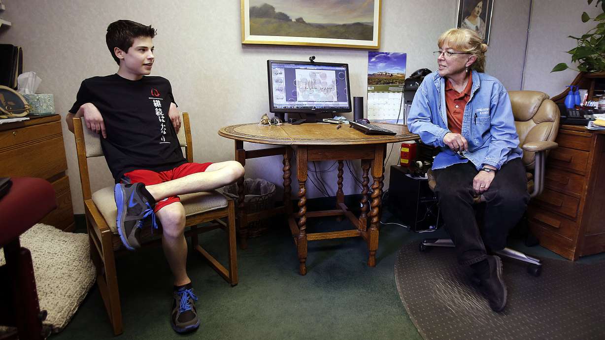 Matt Remes, who has chronic fatigue syndrome, talks about the difficulties he faces with the disease in Salt Lake City, Thursday, May 15, 2014. At right is Dr. Lucinda Bateman.