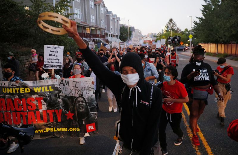 FILE PHOTO: Demonstrators march during a rally against racial inequality and to call for justice a week after Black man Jacob Blake was shot several times by police in Kenosha, in Boston, Massachusetts, U.S., August 30, 2020. REUTERS/Brian Snyder