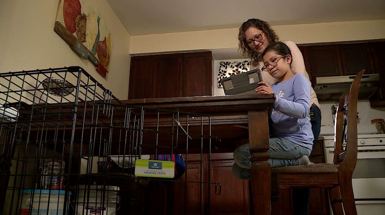 Ana Ocampo helps her daughter Elizah with homework after school. Elizah has a horseshoe kidney and is high risk, which is another reason Ocampo chose to get vaccinated.