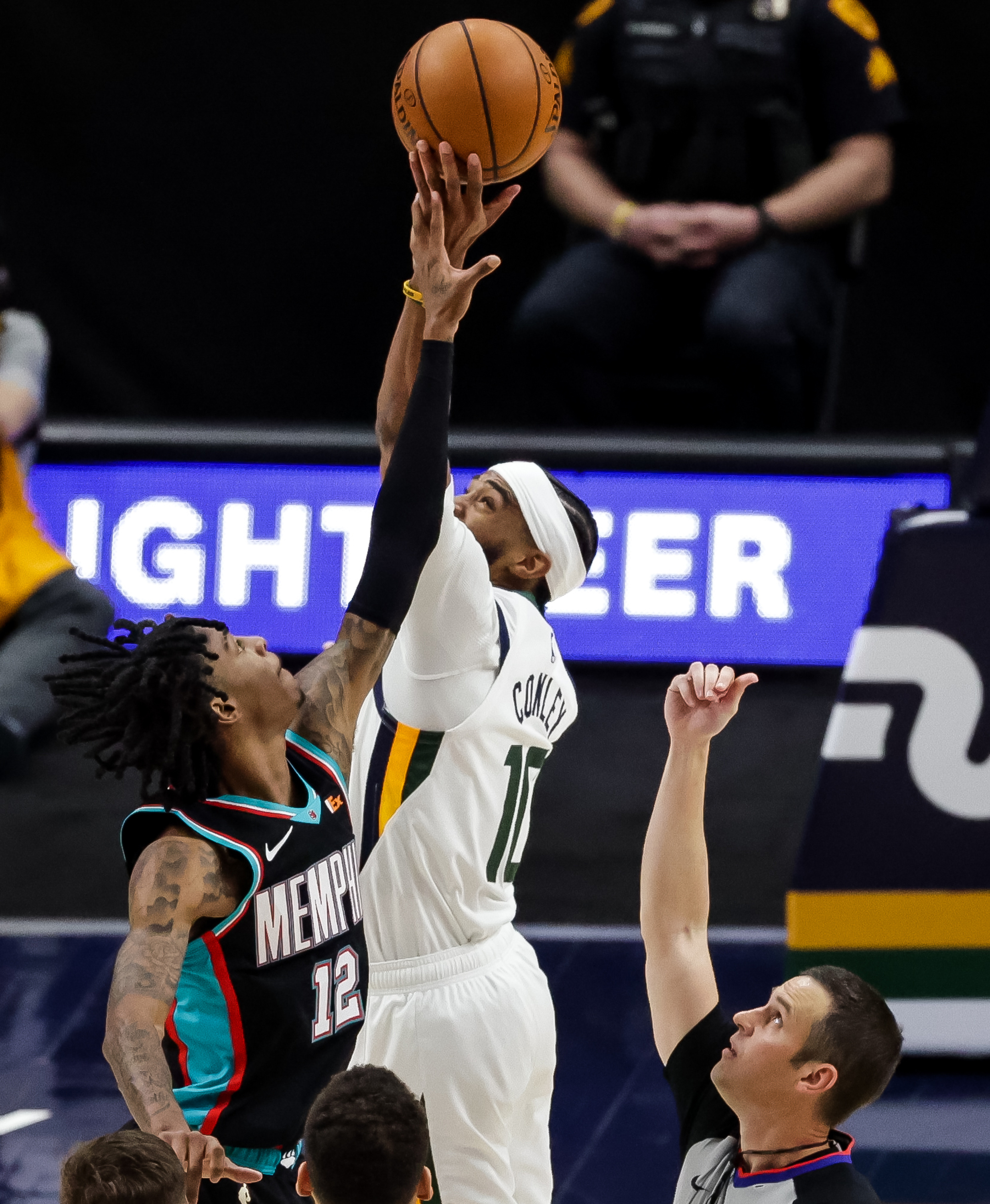 Utah Jazz guard Mike Conley (10) wins a jump ball against Memphis Grizzlies guard Ja Morant (12) in the final seconds of the game at Vivint Smart Home Arena in Salt Lake City on Friday, March 26, 2021.