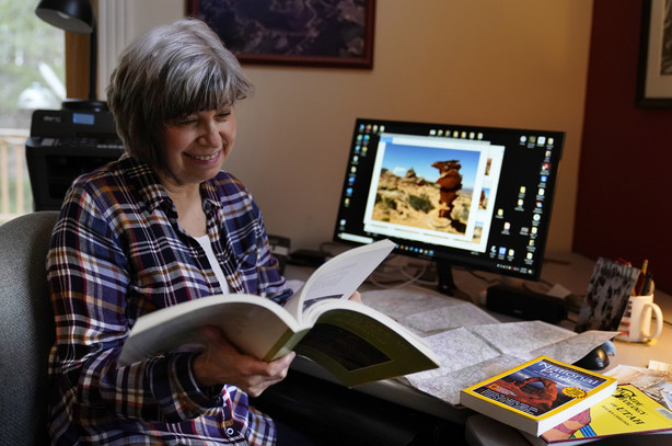 Cindy Charest researches the Southwest with hopes of soon resuming her travels now that she has received the COVID-19 vaccination, Wednesday, march 24, 2021, in Westbrook, Maine. Spring has arrived, and many older adults who have been vaccinated are emerging from hibernation imposed by the coronavirus pandemic.