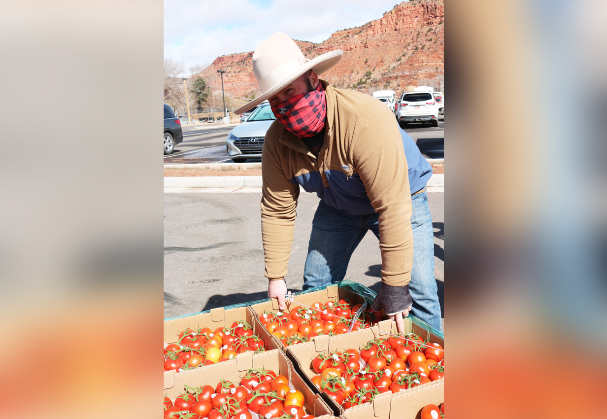 Kyle Wilson poses with tomatoes donated through the Farmers Feeding Utah program for families in Kanab on Friday, March 26, 2021.