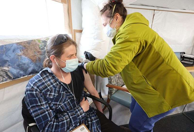 Andrew Nedsker receives a COVID-19 vaccination from Michelle Hicks at the Fourth Street Clinic in Salt Lake City on Tuesday, March 23, 2021.