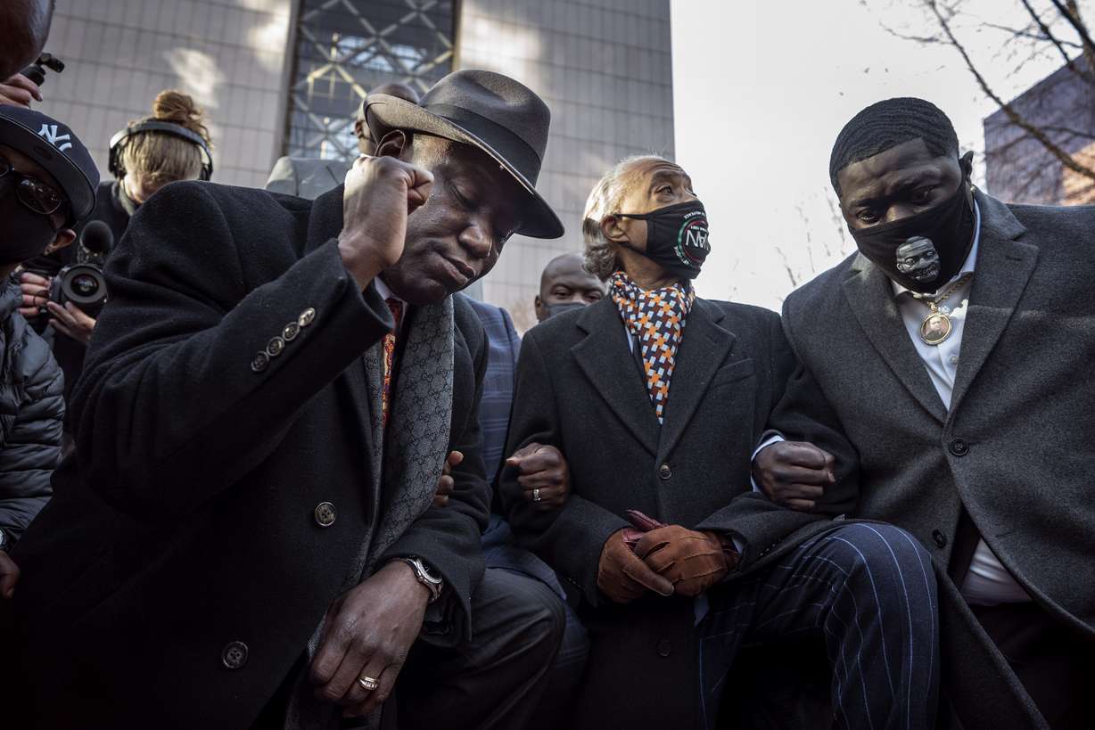 From foreground left, attorney Ben Crump, the Rev. Al Sharpton and Brandon Williams, nephew of George Floyd, take a knee for 8 minutes and 46 seconds during a news conference at the Hennepin County Government Center in Minneapolis, Minn., on the first day of the Derek Chauvin murder trial Monday, March 29, 2021.