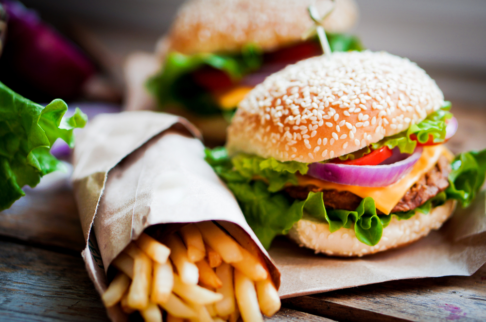 Closeup of home made burgers on wooden background.