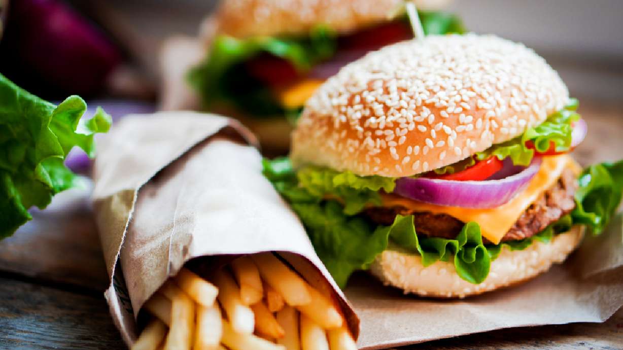 Closeup of home made burgers on wooden background.