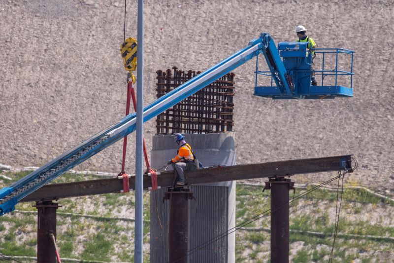 Work crews continue to work on the construction of a freeway overpass in San Diego, California, U.S., March 30, 2021.   REUTERS/Mike Blake