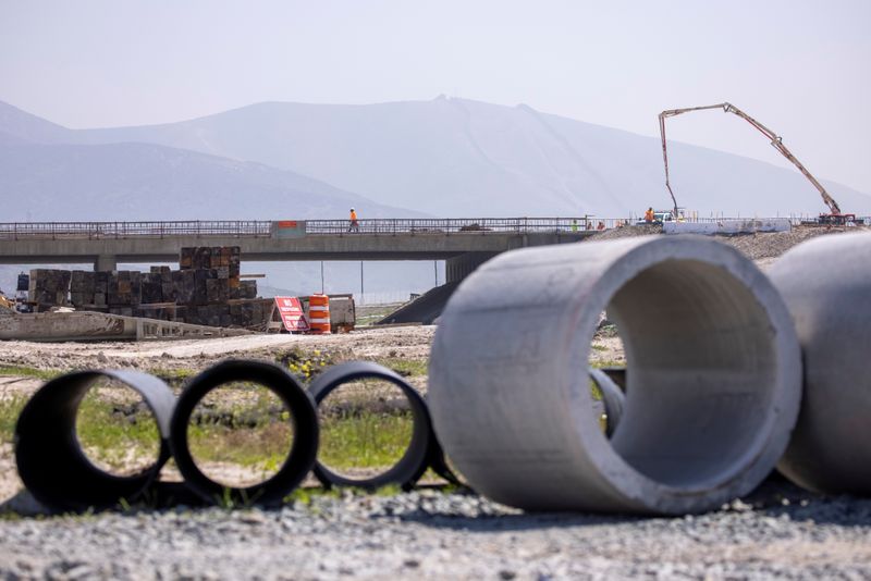Work crews continue to work on the construction of a freeway overpass in San Diego, California, U.S., March 30, 2021.   REUTERS/Mike Blake