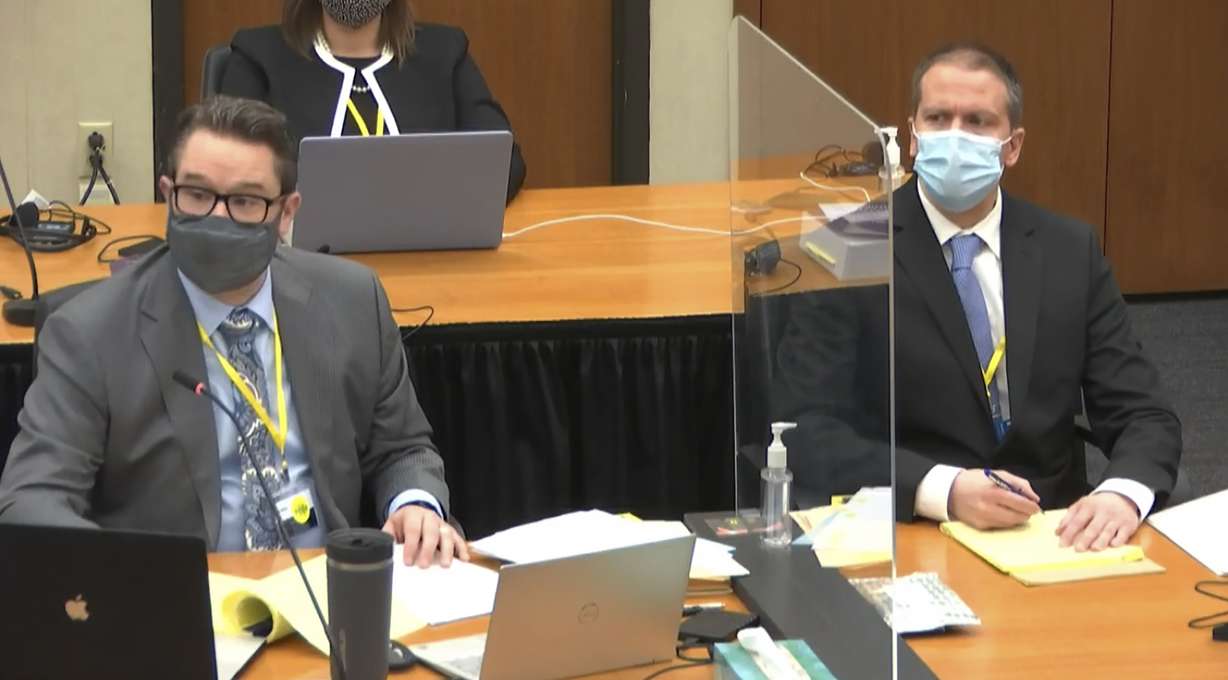 In this image from video, defense attorney Eric Nelson, left, and defendant former Minneapolis police Officer Derek Chauvin listen as Assistant Minnesota Attorney General Matthew Frank, questions witness Christopher Martin as Hennepin County Judge Peter Cahill presides Wednesday, March 31, 2021, in the trial of Chauvin at the Hennepin County Courthouse in Minneapolis, Minn.