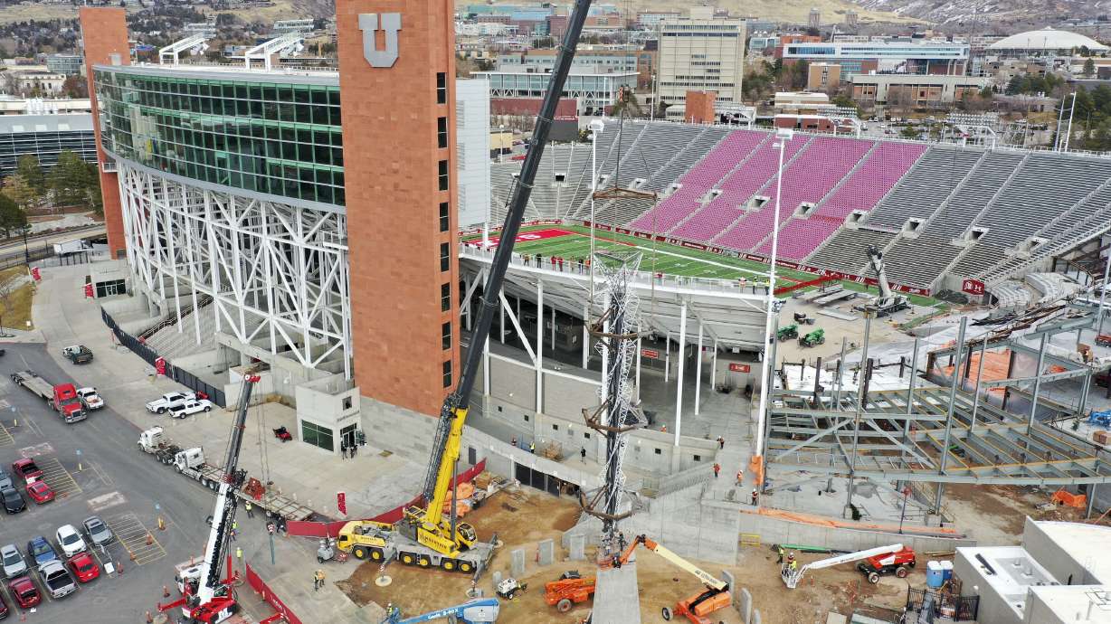 Construction crews use a crane to reinstall the 2002 Olympic cauldron outside of the University of Utahâs Rice-Eccles Stadium in Salt Lake City on Friday, Jan. 29, 2021.