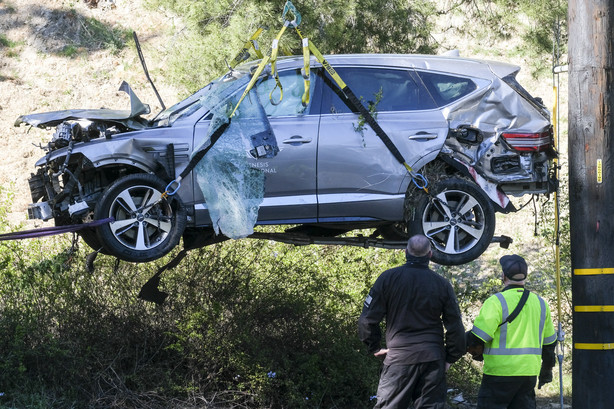 FILE - In this Feb. 23, 2021, file photo a crane is used to lift a vehicle following a rollover accident involving golfer Tiger Woods, in the Rancho Palos Verdes suburb of Los Angeles. The Los Angeles County sheriff says detectives have determined what caused Woods to crash his SUV last month in Southern California but would not release details on Wednesday, March 31, 2021, citing privacy concerns for the golf star.